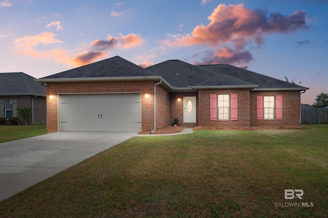 view of front of property featuring a yard and a garage