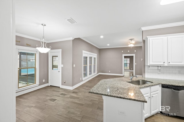 kitchen featuring white cabinets, dishwasher, a healthy amount of sunlight, and sink