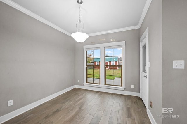 unfurnished dining area with wood-type flooring and ornamental molding