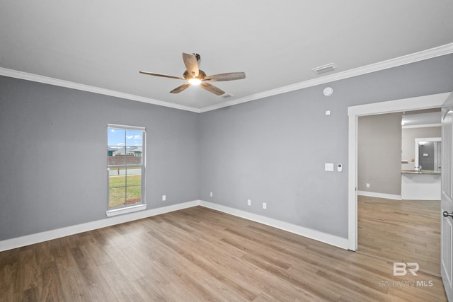 unfurnished room featuring ceiling fan, light wood-type flooring, and crown molding