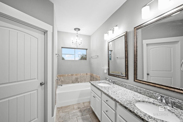 bathroom featuring a tub to relax in, vanity, and a chandelier