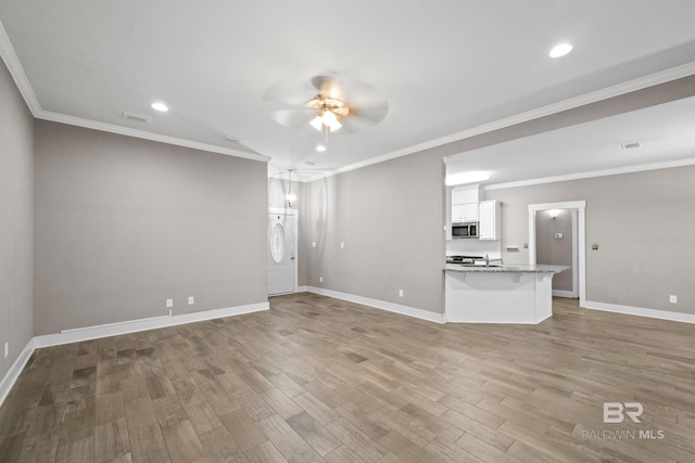 unfurnished living room featuring light hardwood / wood-style flooring, ceiling fan, ornamental molding, and sink