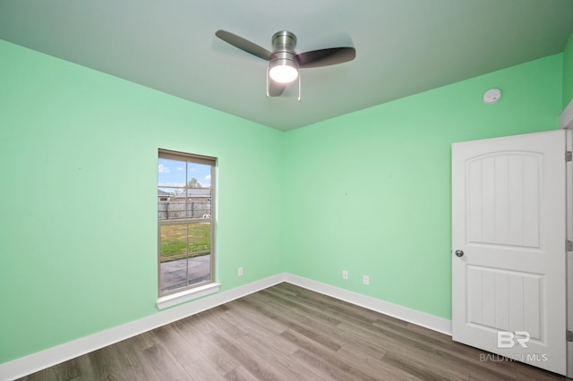 empty room with ceiling fan and hardwood / wood-style flooring