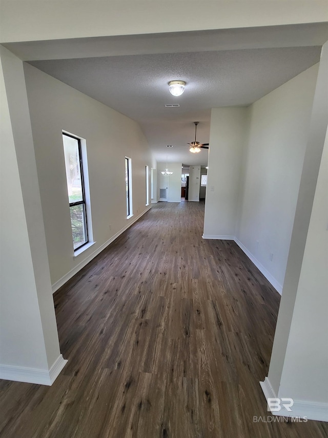 hallway featuring dark wood-style floors and baseboards