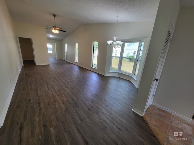 unfurnished dining area featuring a chandelier, dark wood-style floors, baseboards, lofted ceiling, and a ceiling fan