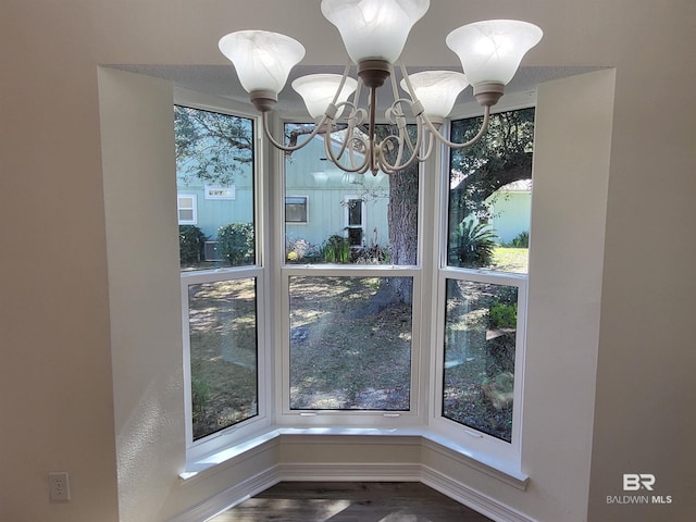 detailed view of a chandelier and wood finished floors