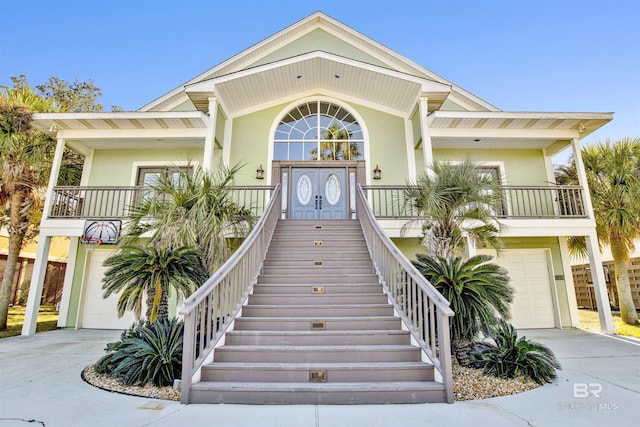 view of exterior entry with covered porch and a garage