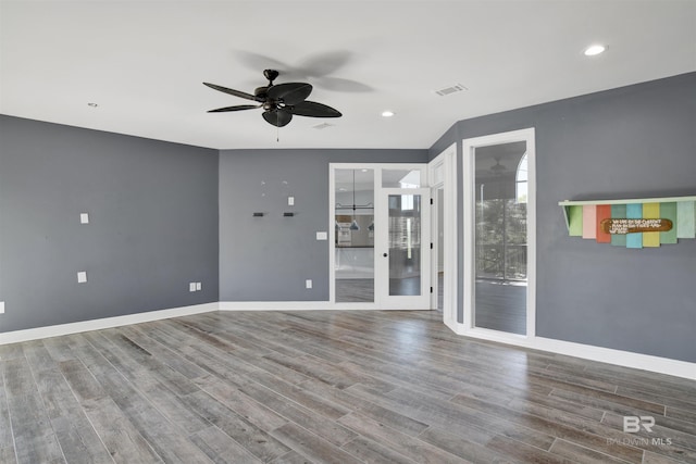 empty room featuring hardwood / wood-style flooring and ceiling fan