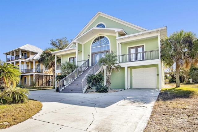 beach home with french doors, covered porch, and a garage