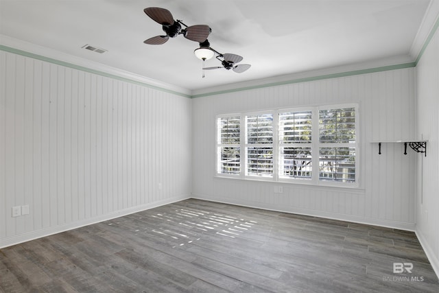 unfurnished room featuring hardwood / wood-style flooring, ceiling fan, and crown molding