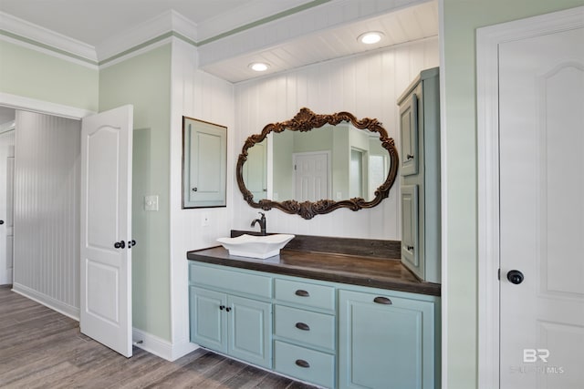 bathroom featuring hardwood / wood-style floors, vanity, and crown molding