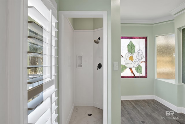 bathroom with wood-type flooring and ornamental molding