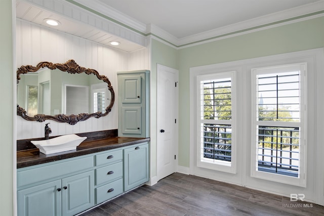 bathroom featuring hardwood / wood-style floors, vanity, and crown molding