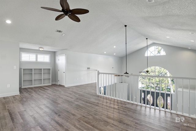 spare room with ceiling fan, a textured ceiling, and vaulted ceiling