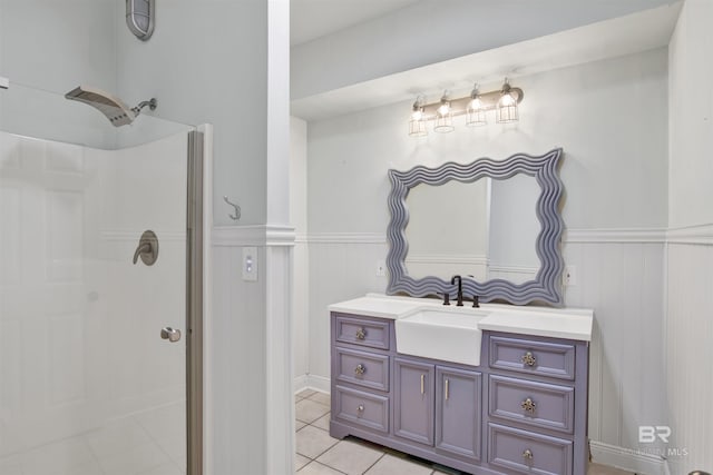 bathroom with tile patterned floors, vanity, and walk in shower