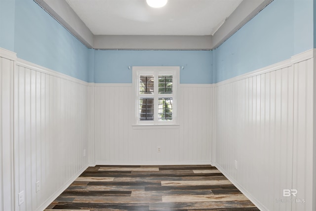 unfurnished room with dark wood-type flooring