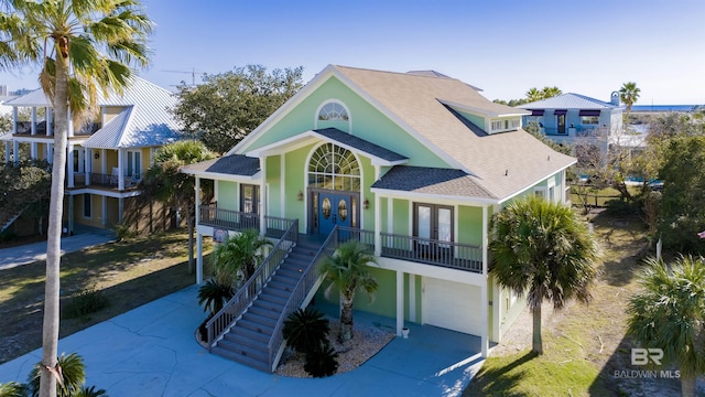 raised beach house featuring french doors and a garage