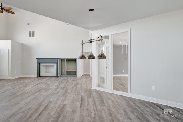 unfurnished dining area with ceiling fan and hardwood / wood-style flooring