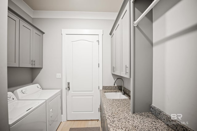 467 Colony Dr, Fairhope, AL 36532 - laundry room with washing machine and clothes dryer, cabinet space, and light wood-type flooring
