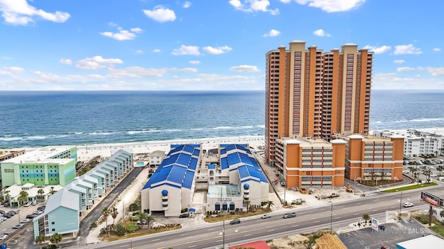 birds eye view of property with a beach view and a water view