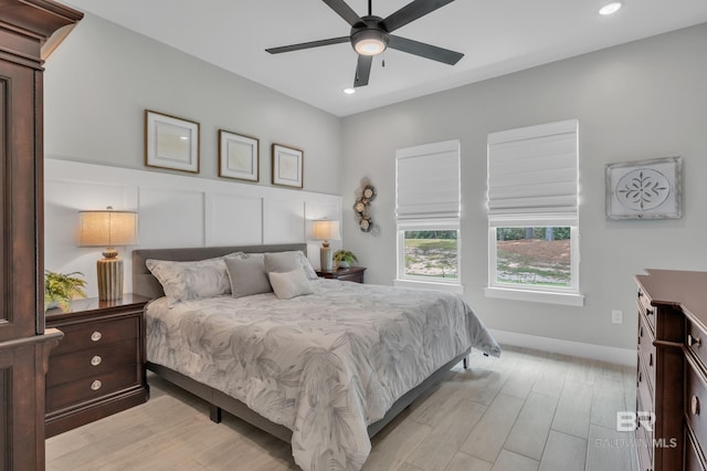 bedroom with light wood-style floors, a ceiling fan, and recessed lighting