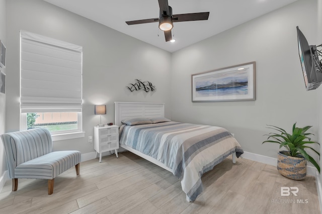 bedroom with baseboards, a ceiling fan, and wood finished floors