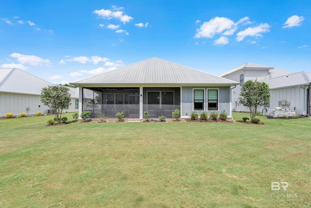 view of front of house featuring a sunroom and a front lawn