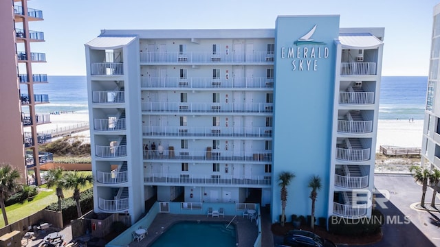 view of property with a beach view and a water view