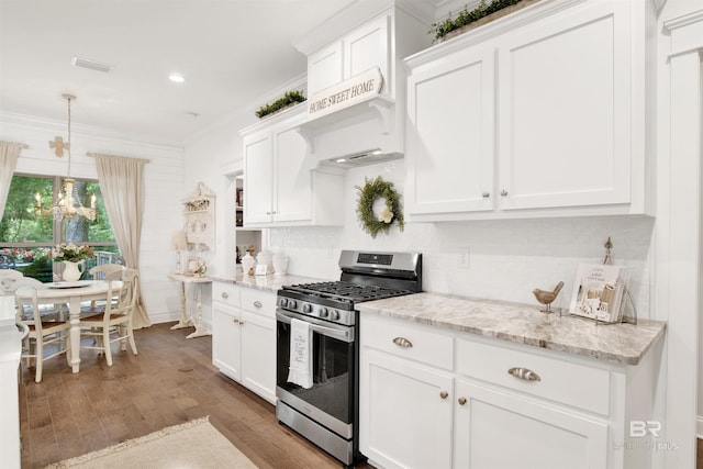 kitchen with white cabinetry, wood finished floors, stainless steel gas range, and tasteful backsplash