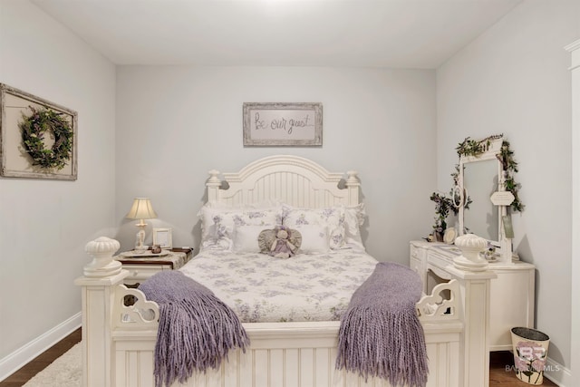 bedroom featuring baseboards and dark wood finished floors