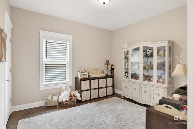 interior space featuring baseboards and wood finished floors