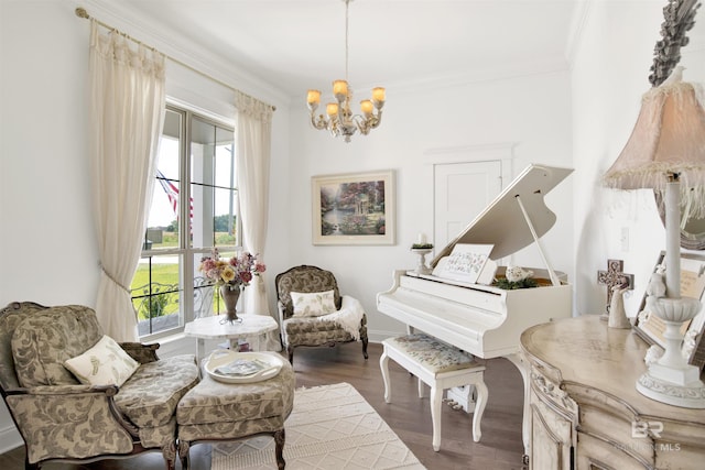 living area with crown molding, baseboards, an inviting chandelier, and wood finished floors