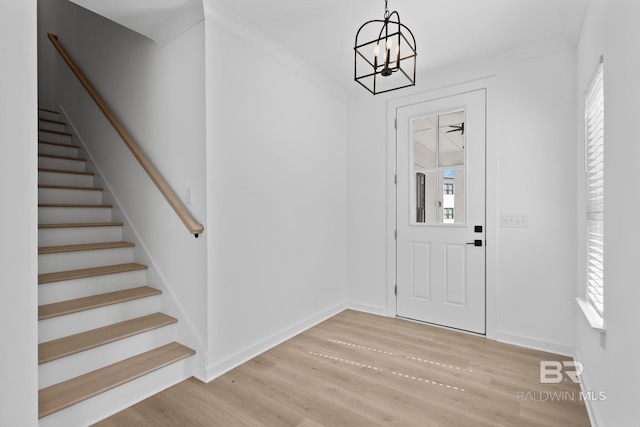 entrance foyer with plenty of natural light, wood finished floors, and stairs