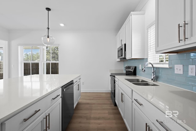 kitchen featuring tasteful backsplash, stainless steel appliances, a wealth of natural light, and a sink