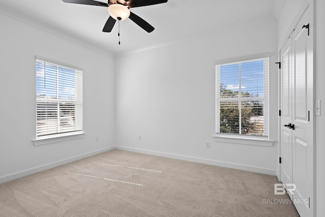 unfurnished room featuring light colored carpet, baseboards, and ceiling fan