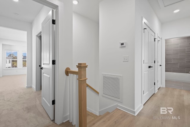 hall with an upstairs landing, visible vents, recessed lighting, and baseboards