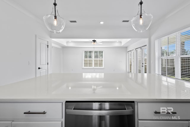 kitchen with visible vents, a raised ceiling, dishwasher, and light countertops