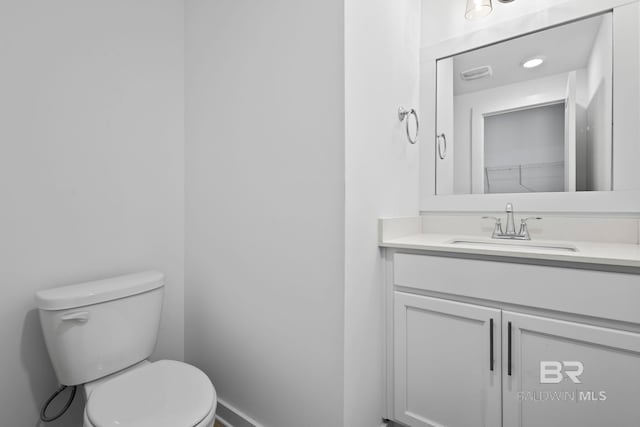 half bath with vanity and toilet