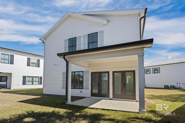 back of property featuring a patio area, central AC unit, french doors, and a lawn