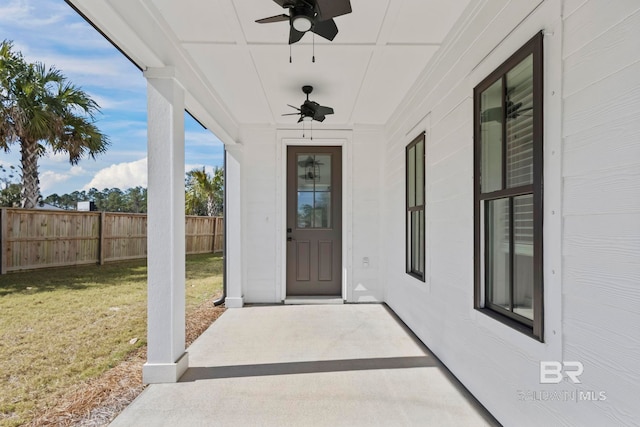 doorway to property with a yard, a ceiling fan, and fence