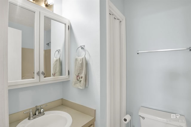 bathroom featuring toilet and vanity