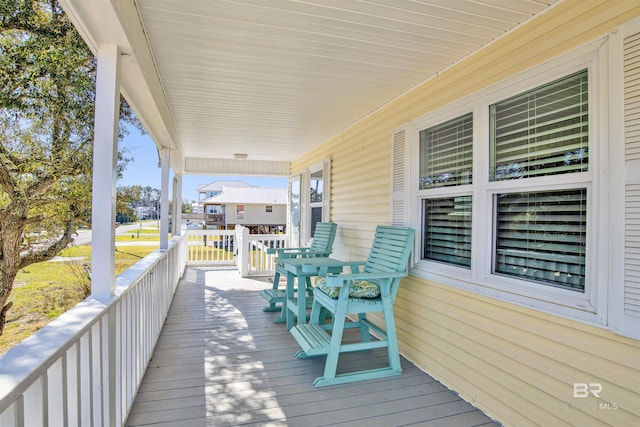 wooden terrace featuring covered porch