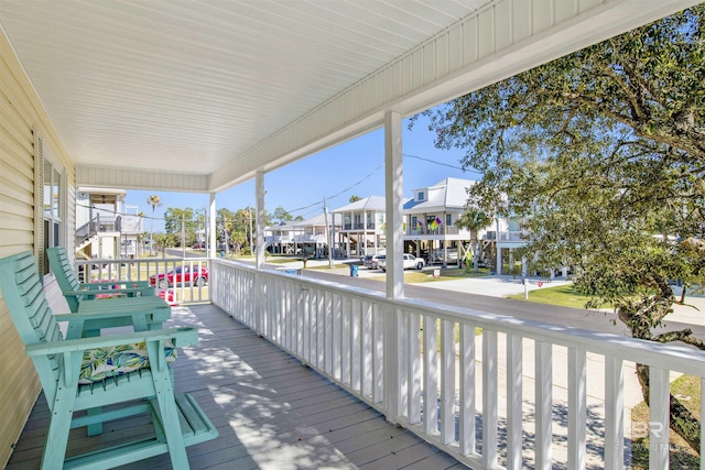 deck with covered porch and a residential view