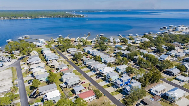 drone / aerial view with a water view and a residential view