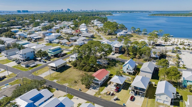 drone / aerial view with a water view and a residential view