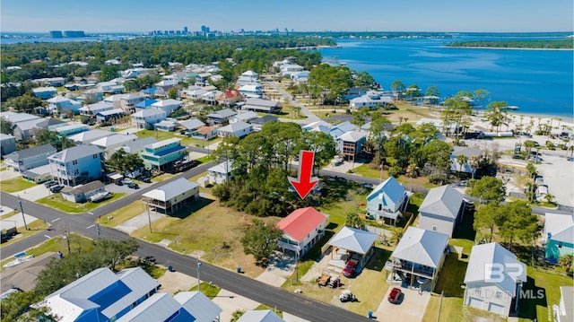 birds eye view of property featuring a water view and a residential view