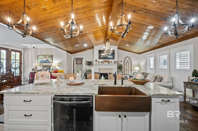 kitchen featuring a wealth of natural light, dark hardwood / wood-style floors, lofted ceiling, and black dishwasher