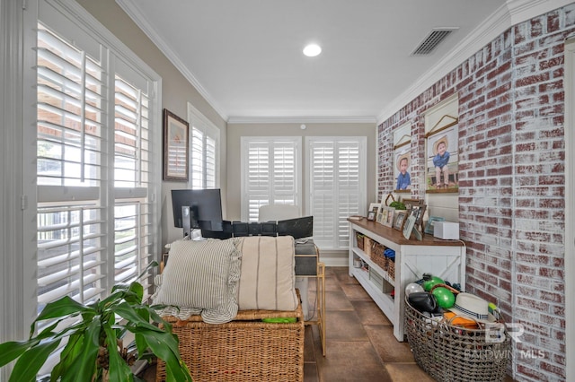 interior space with ornamental molding and brick wall