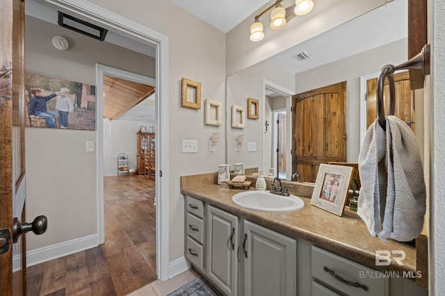 bathroom featuring hardwood / wood-style flooring and vanity