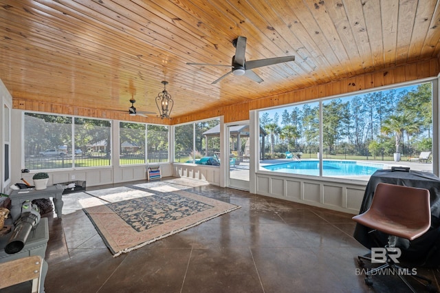 sunroom / solarium featuring ceiling fan and wood ceiling